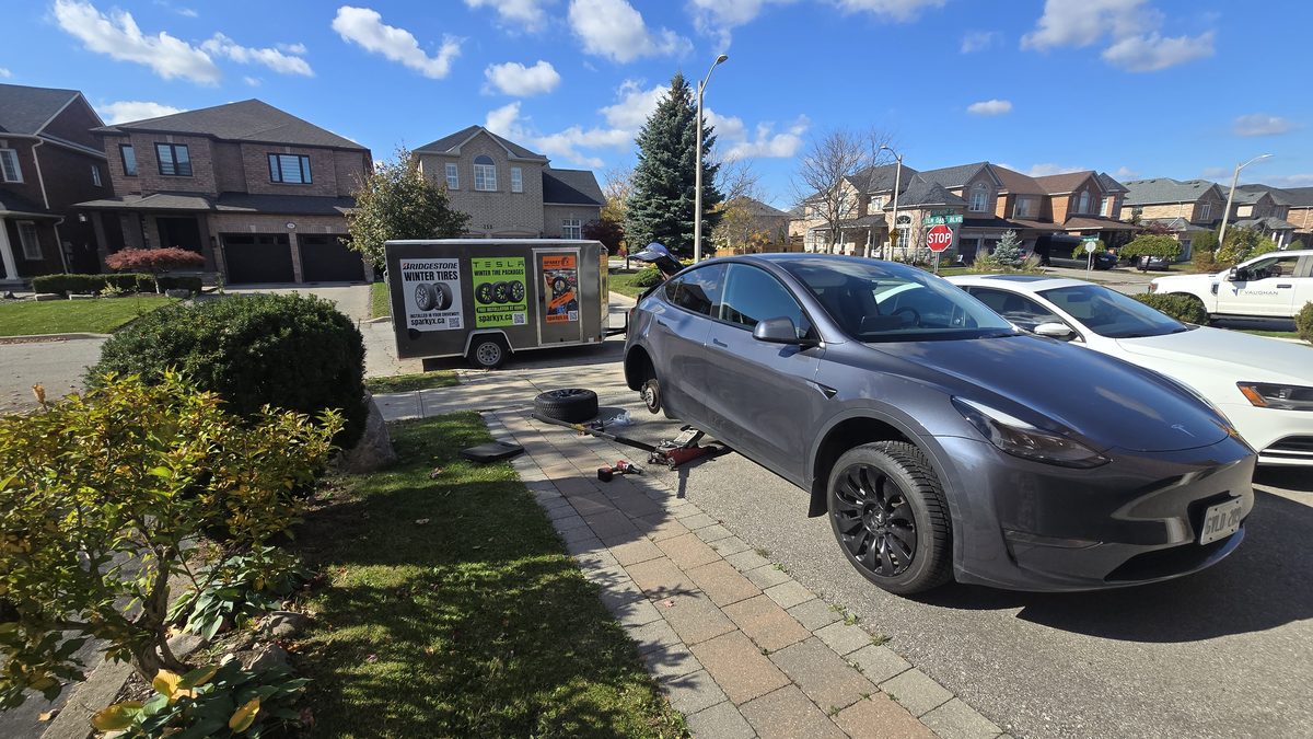 Sparky X mobile tire service in Pickering — set up in a customer's driveway, vehicle on the jack, tools laid out, ready to work