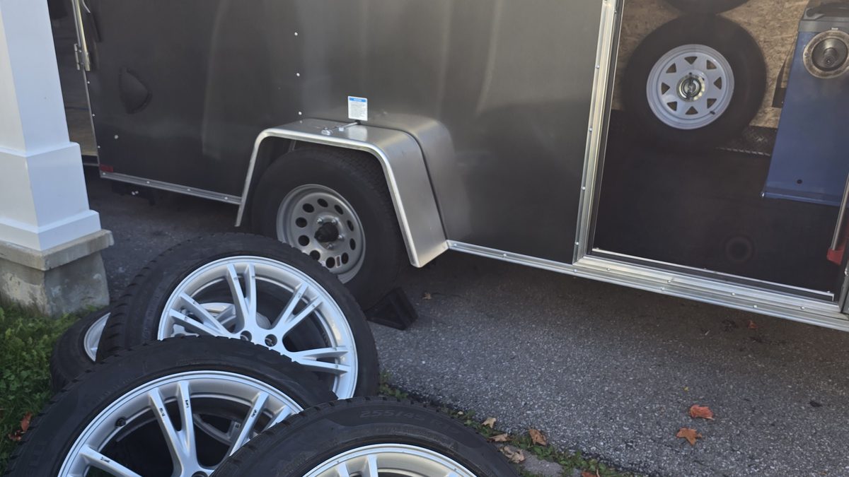 A set of new tires and alloy wheels by the Sparky X trailer — the kind of qualifying set of four a manufacturer rebate applies to